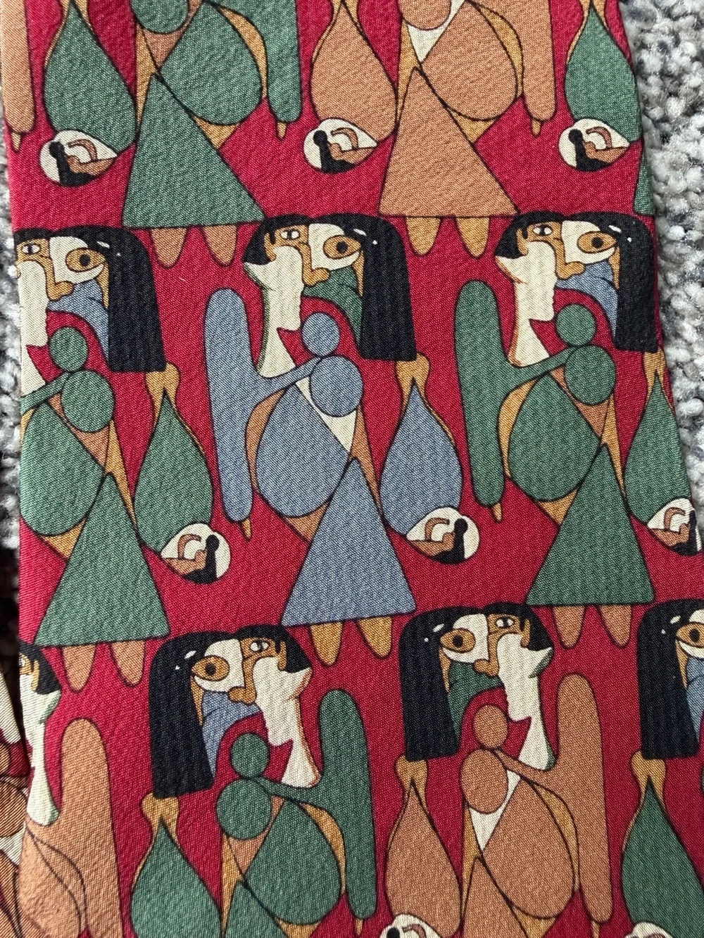 silk tie with abstract geometric pattern in red, green, and brown